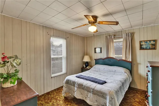 a bedroom with a bed and a potted plant