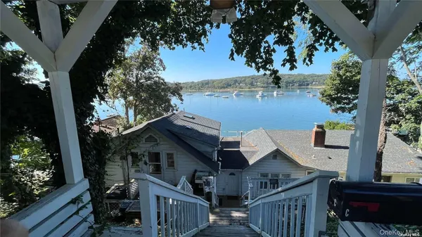 a view of house with backyard and deck