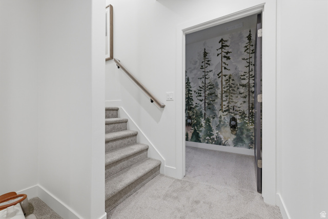 2559 West Aurora Avenue Mapleton, UT 84664 - Photo 39 of 60 Carpeted staircase with a wood-finish handrail and white risers