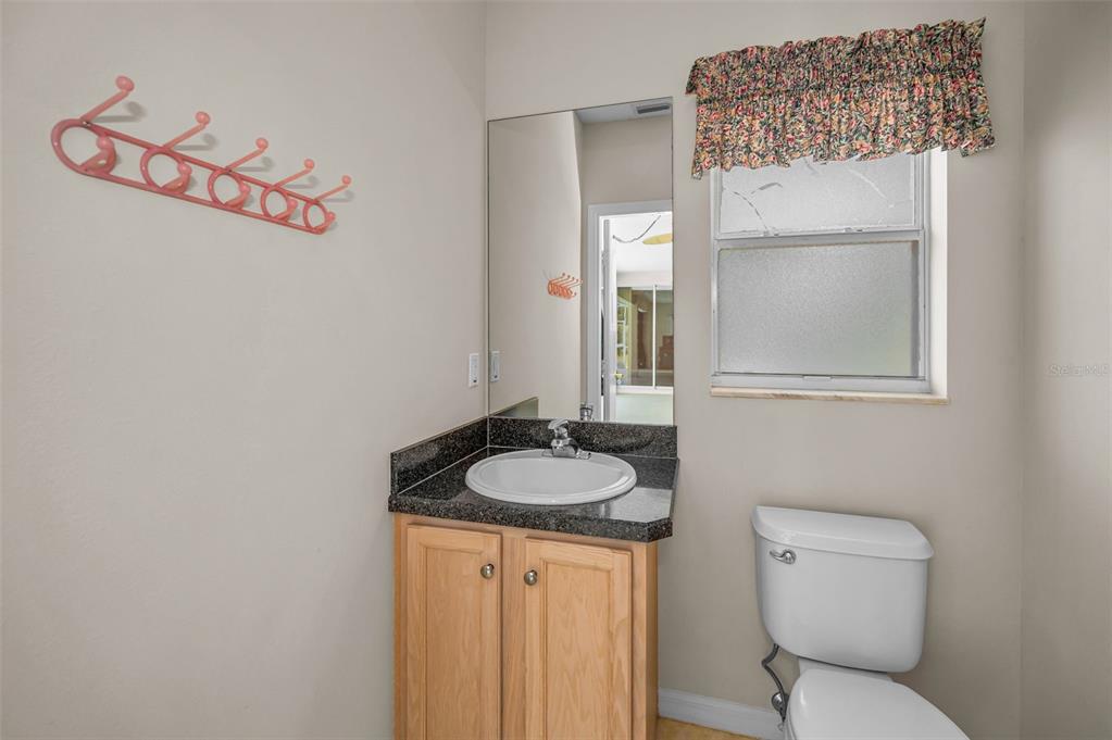 11917 Hadleigh Way Trinity, FL 34655 - Photo 42 of 84 a bathroom with a granite countertop sink and a mirror with toilet