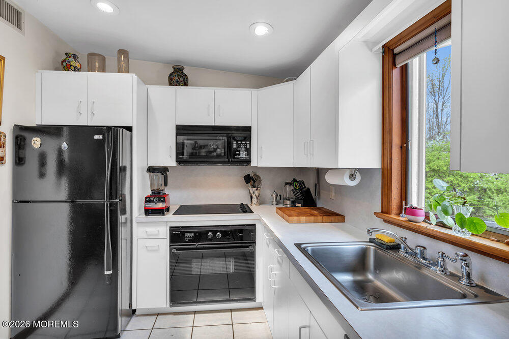 34 State Route Colts Neck, NJ 07722 - Photo 11 of 40 a kitchen with a refrigerator sink and stove