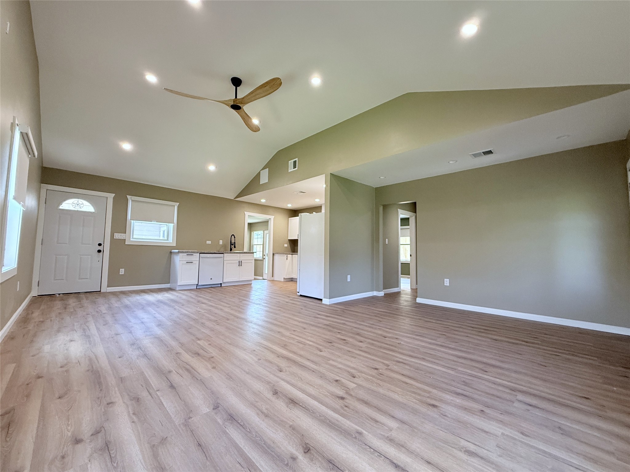 1922 Tabor Street Houston, TX 77009 - Photo 11 of 24 In the kitchen, beyond the door on the left, is the paved patio & gate to the carport. From the living room, a hallway leads to the two secondary bedrooms & bath.