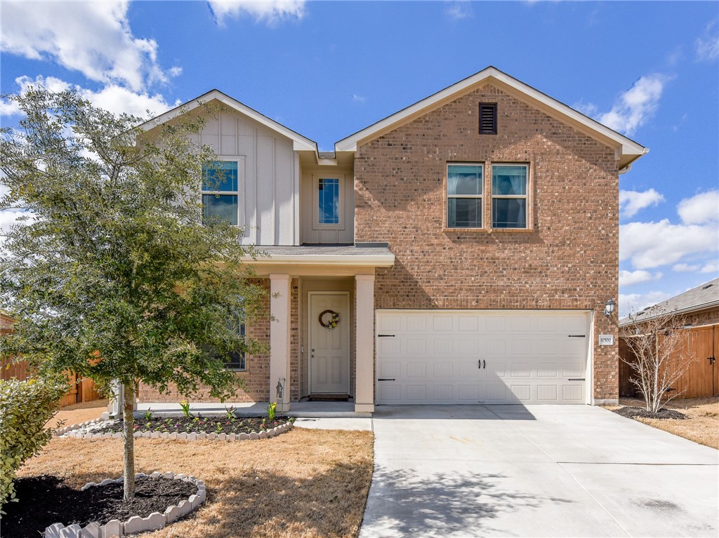 11500 Maple Leaf Way Manor, TX 78653 - Photo 1 of 1 a front view of a house with a yard