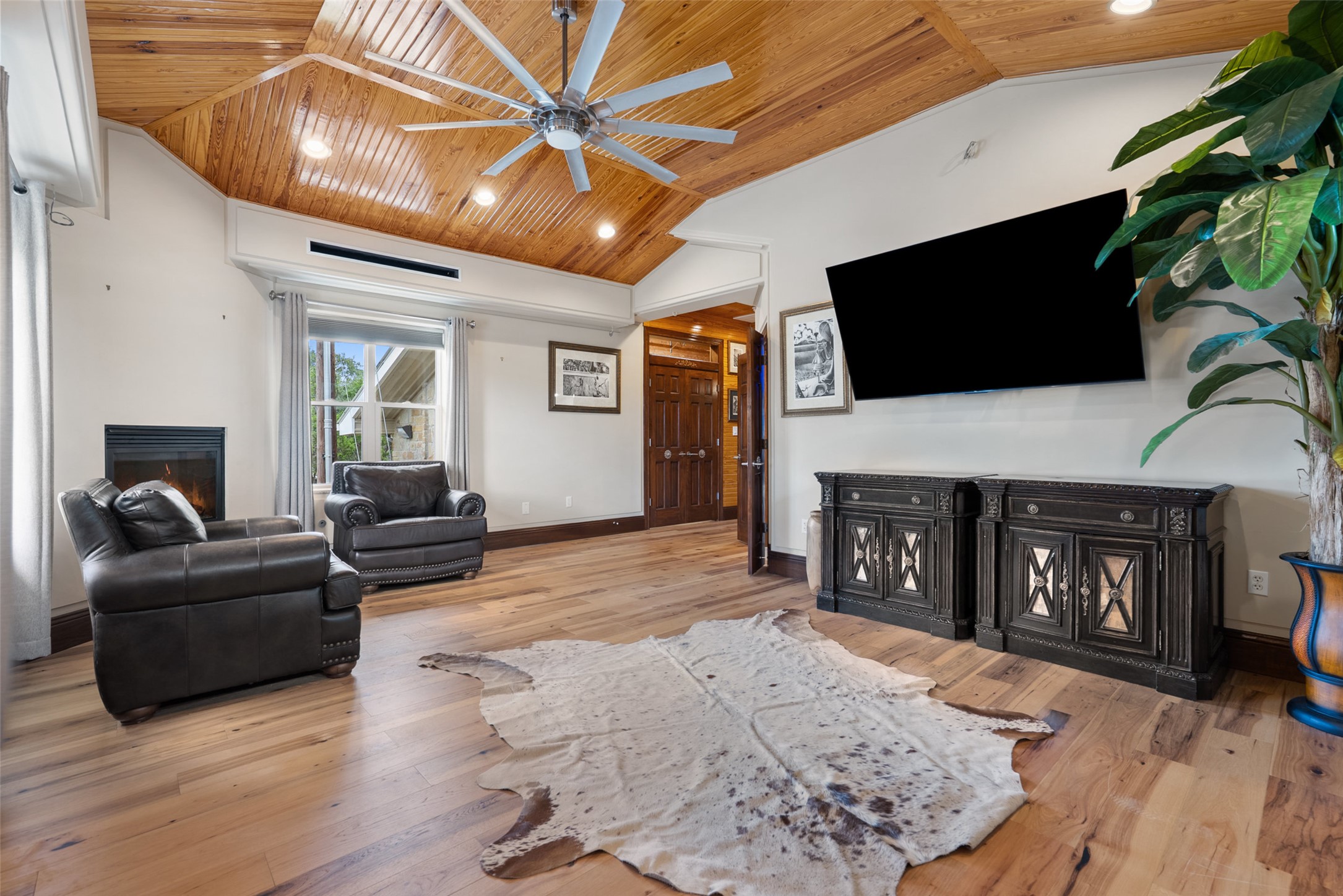 15303 Faubion Trail Leander, TX 78641 - Photo 11 of 39 a living room with furniture a fireplace and a flat screen tv