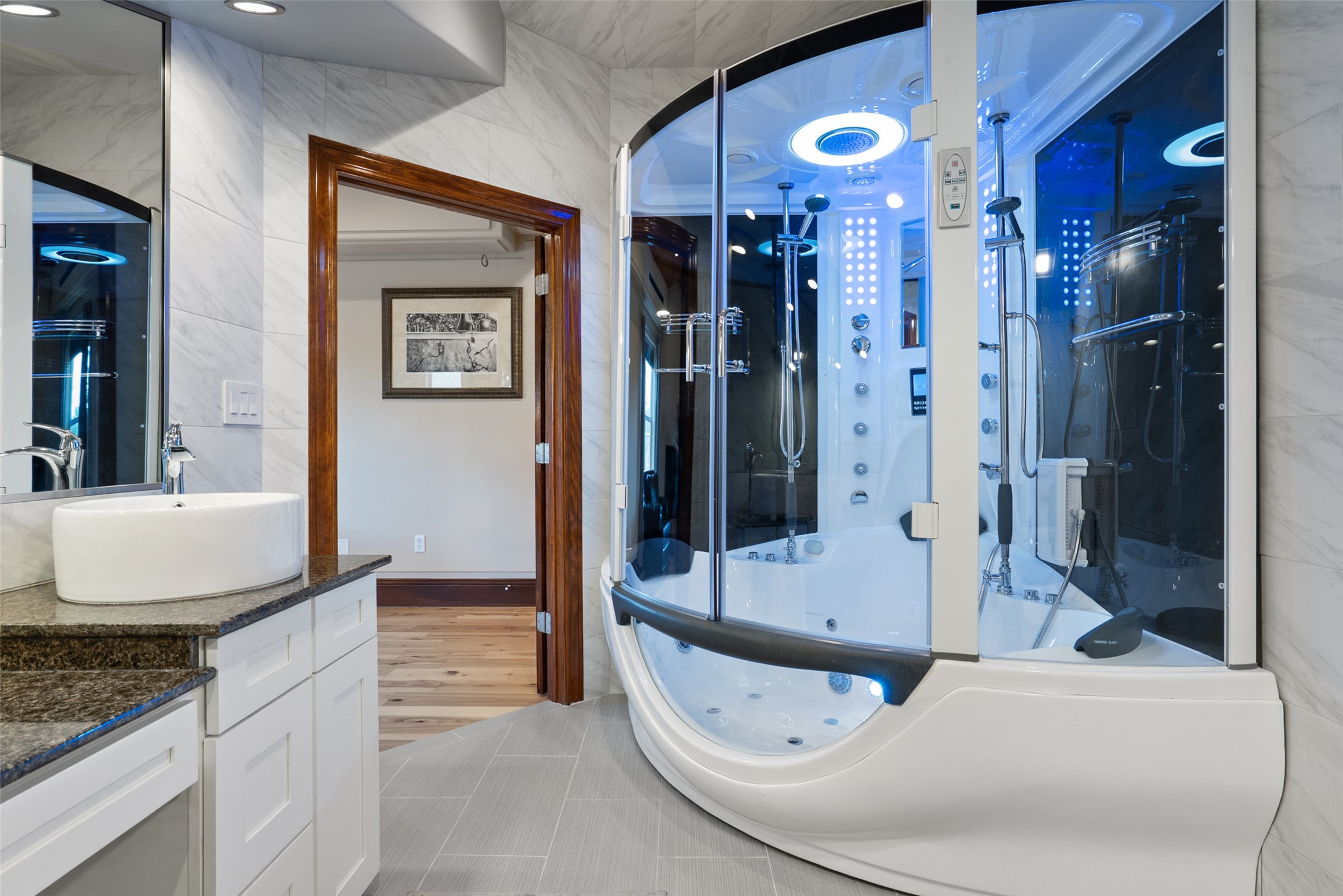 15303 Faubion Trail Leander, TX 78641 - Photo 12 of 39 a bathroom with a granite countertop sink a mirror and shower