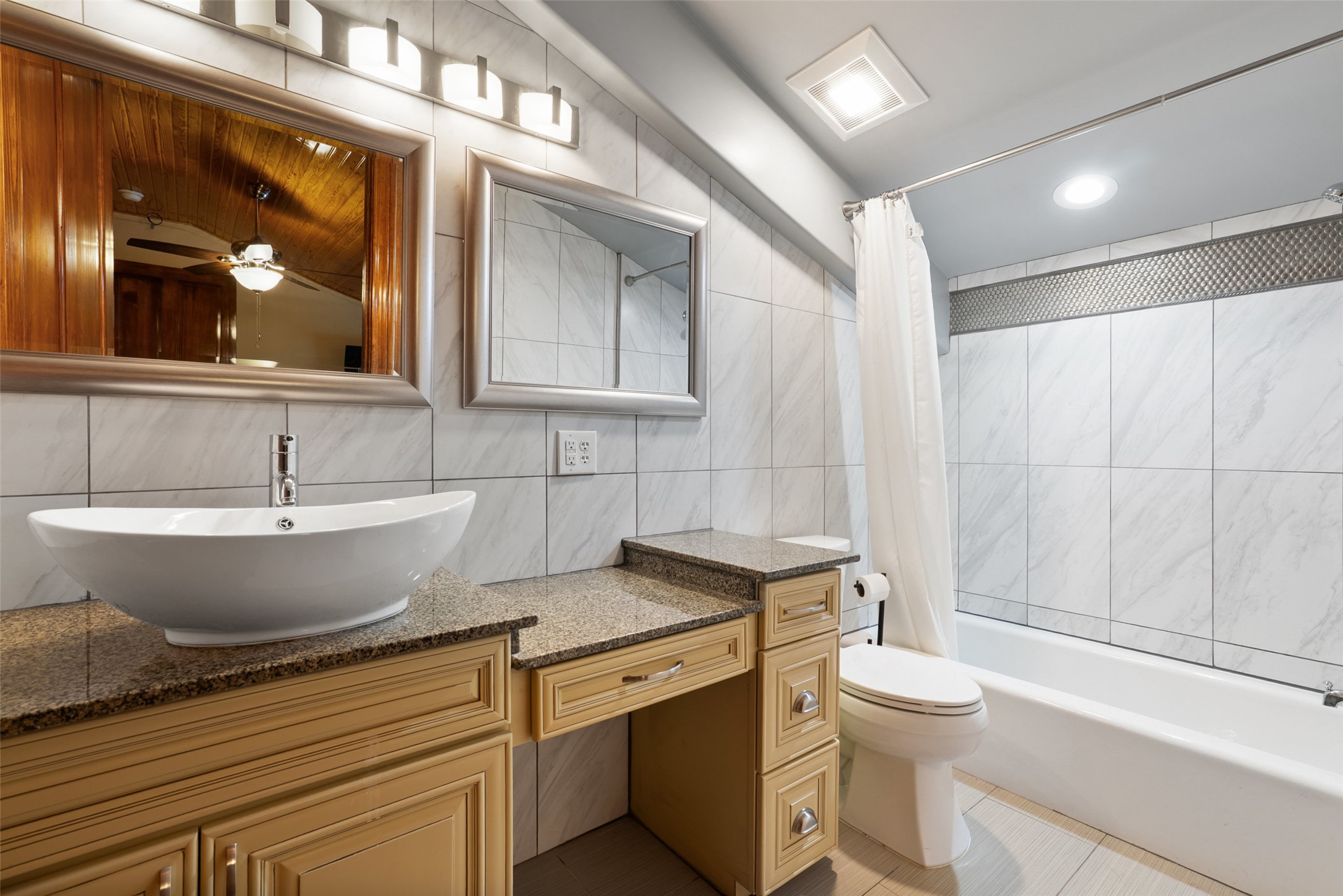 15303 Faubion Trail Leander, TX 78641 - Photo 16 of 39 a view of a bathroom with a granite countertop sink mirror and a toilet