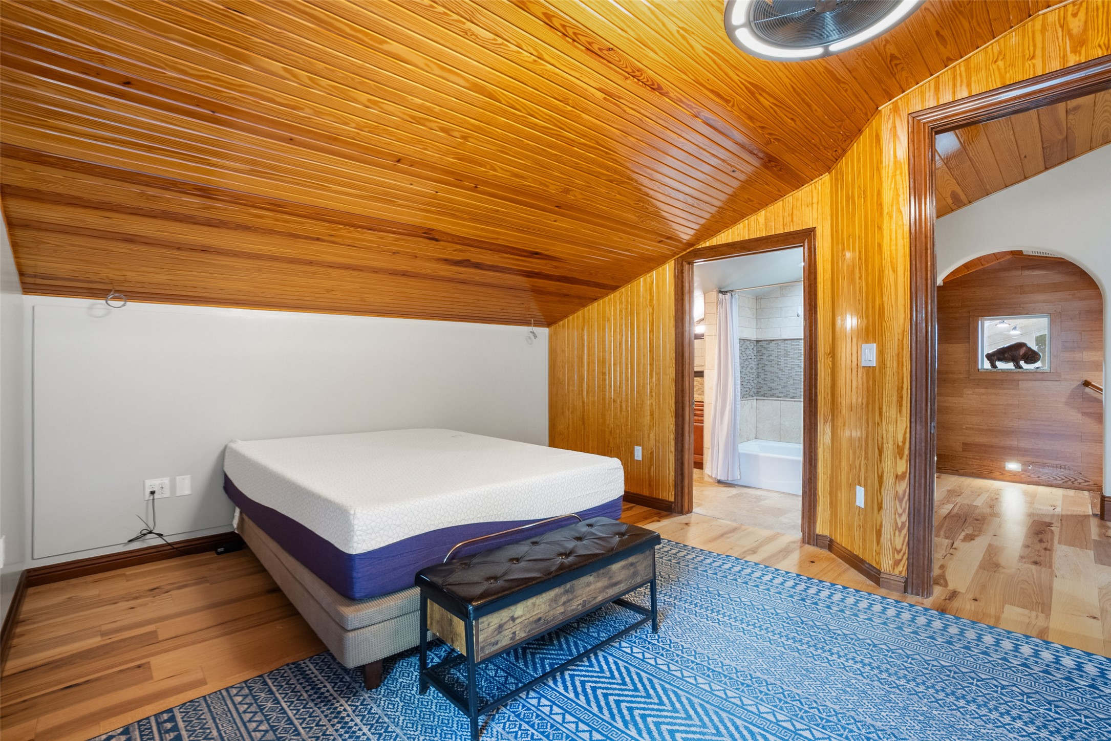 15303 Faubion Trail Leander, TX 78641 - Photo 17 of 39 a spacious bedroom with a bed and wooden floor