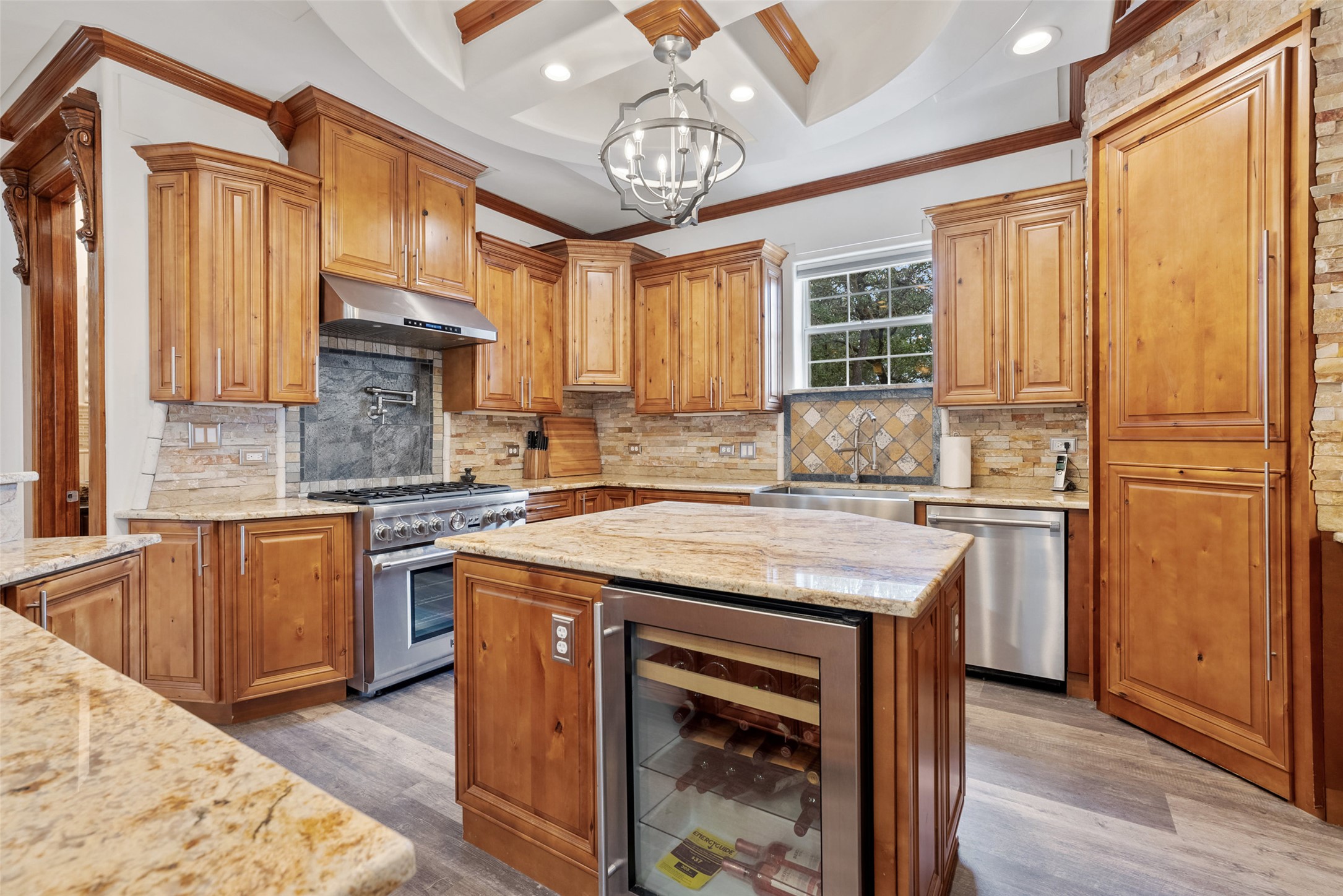 15303 Faubion Trail Leander, TX 78641 - Photo 8 of 39 a kitchen with stainless steel appliances granite countertop a stove a sink dishwasher and a refrigerator with wooden floor