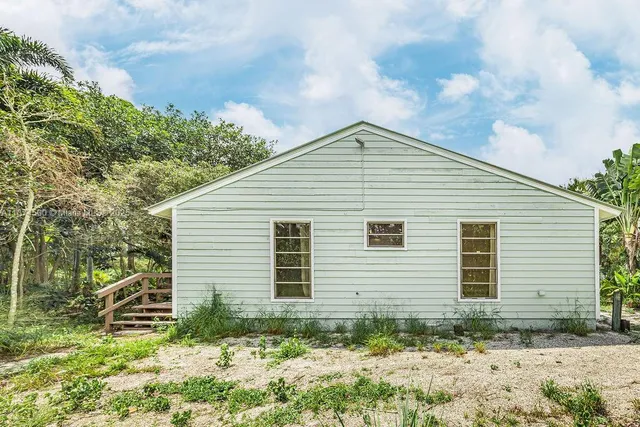 a backyard of a house with lots of trees