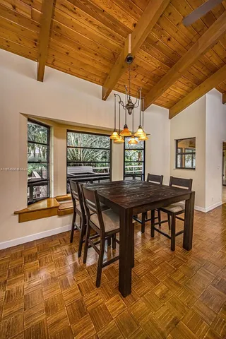 a kitchen with stainless steel appliances kitchen island granite countertop a sink cabinets and wooden floor