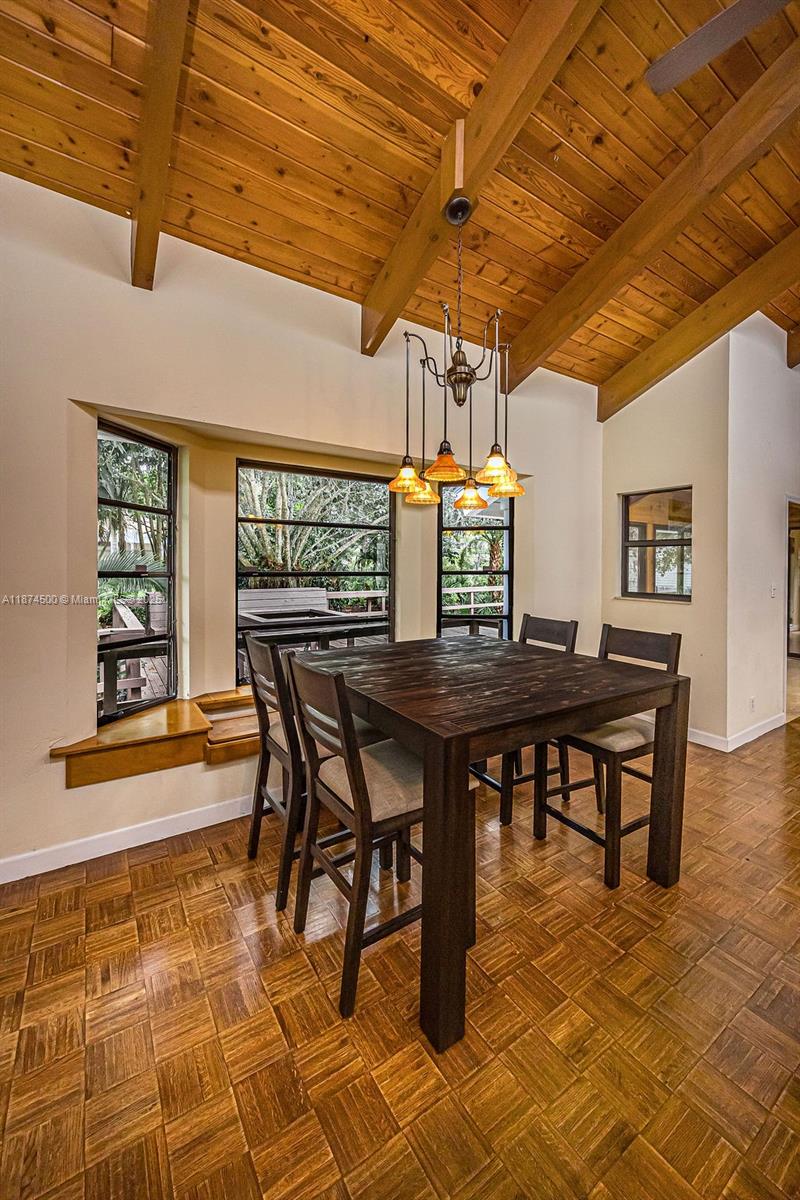 4882 Southeast Bayshore Terrace Stuart, FL 34997 - Photo 26 of 56 a dining room with furniture and window