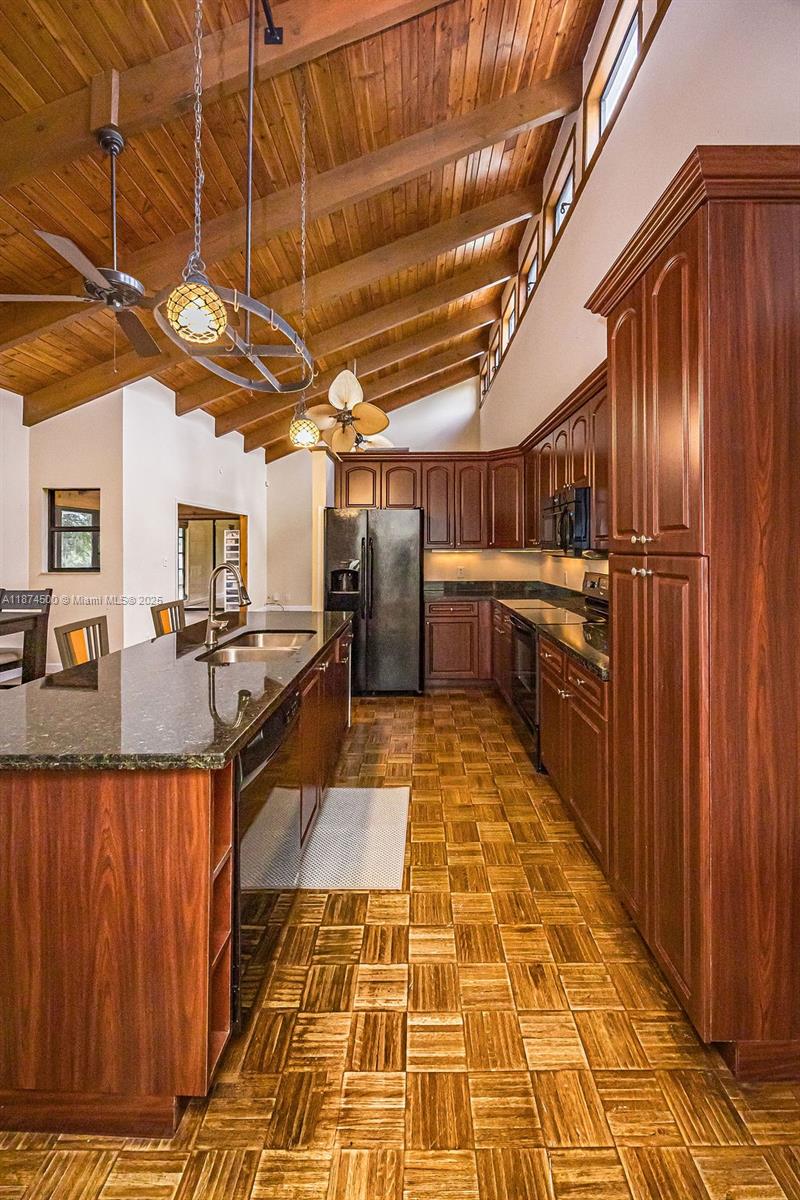 4882 Southeast Bayshore Terrace Stuart, FL 34997 - Photo 27 of 56 a view of a refrigerator with wooden floor
