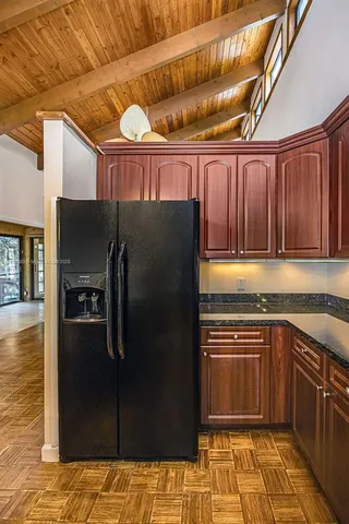 a view of a livingroom with wooden floor and a rug