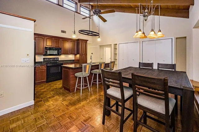 a kitchen with a dining table and chairs