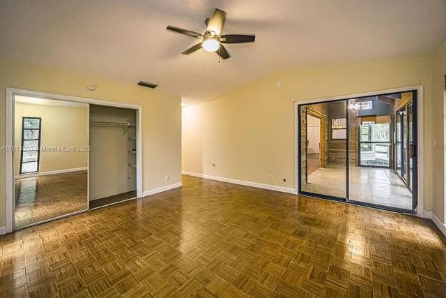 an empty room with windows and closet