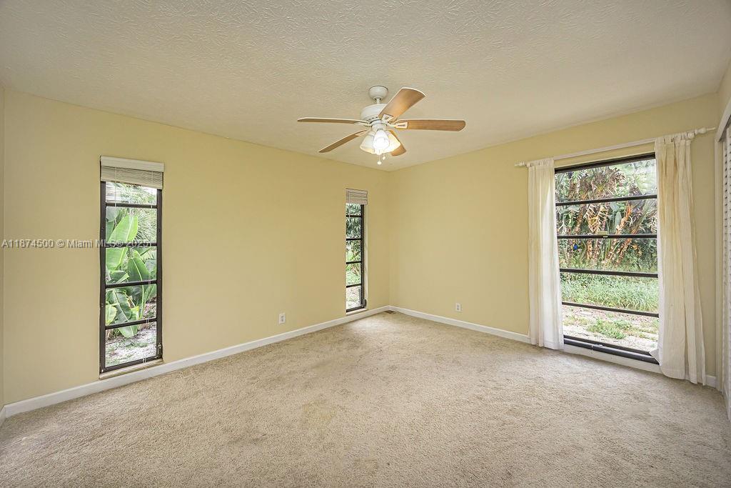 4882 Southeast Bayshore Terrace Stuart, FL 34997 - Photo 40 of 56 an empty room with windows and closet