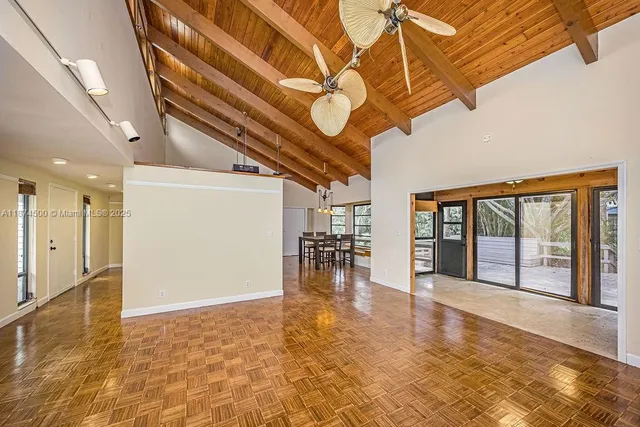 a view of a livingroom with furniture staircase and a ceiling fan