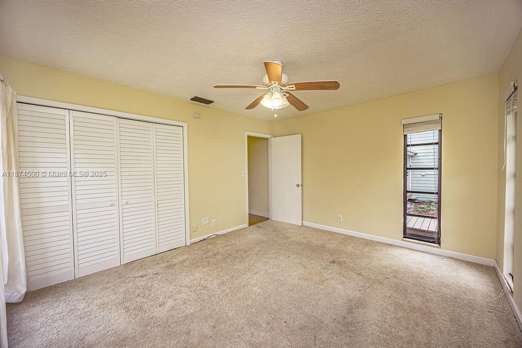 4882 Southeast Bayshore Terrace Stuart, FL 34997 - Photo 42 of 56 a view of a room with a ceiling fan and a window