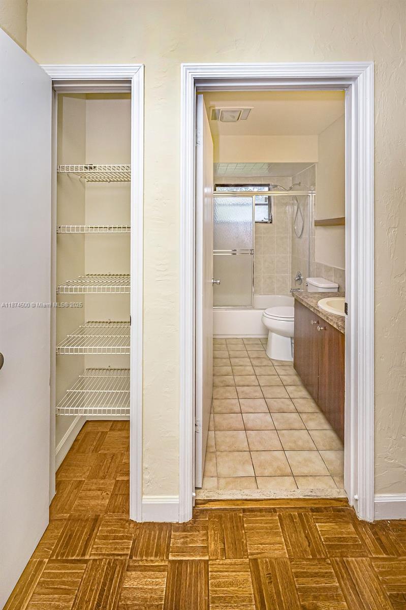 4882 Southeast Bayshore Terrace Stuart, FL 34997 - Photo 45 of 56 a bathroom with a glass shower door and a bathtub