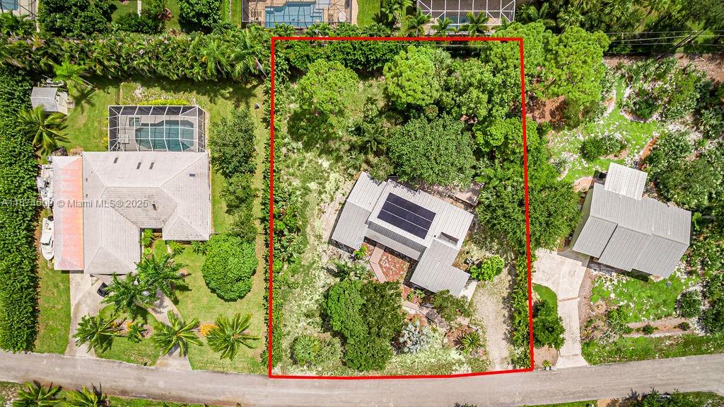 4882 Southeast Bayshore Terrace Stuart, FL 34997 - Photo 49 of 56 an aerial view of a house with a yard and garden