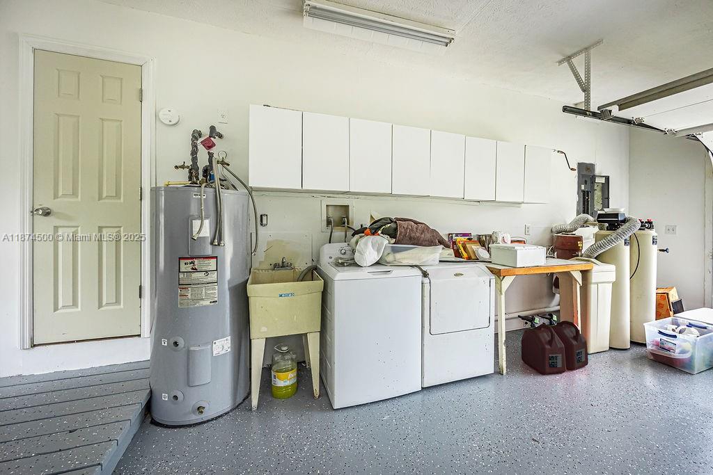 4882 Southeast Bayshore Terrace Stuart, FL 34997 - Photo 52 of 56 a utility room with dryer and washer