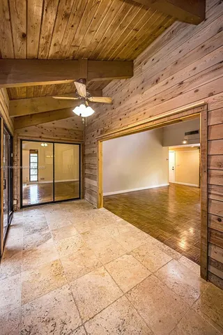 a view of a patio with table and chairs with wooden floor and fence