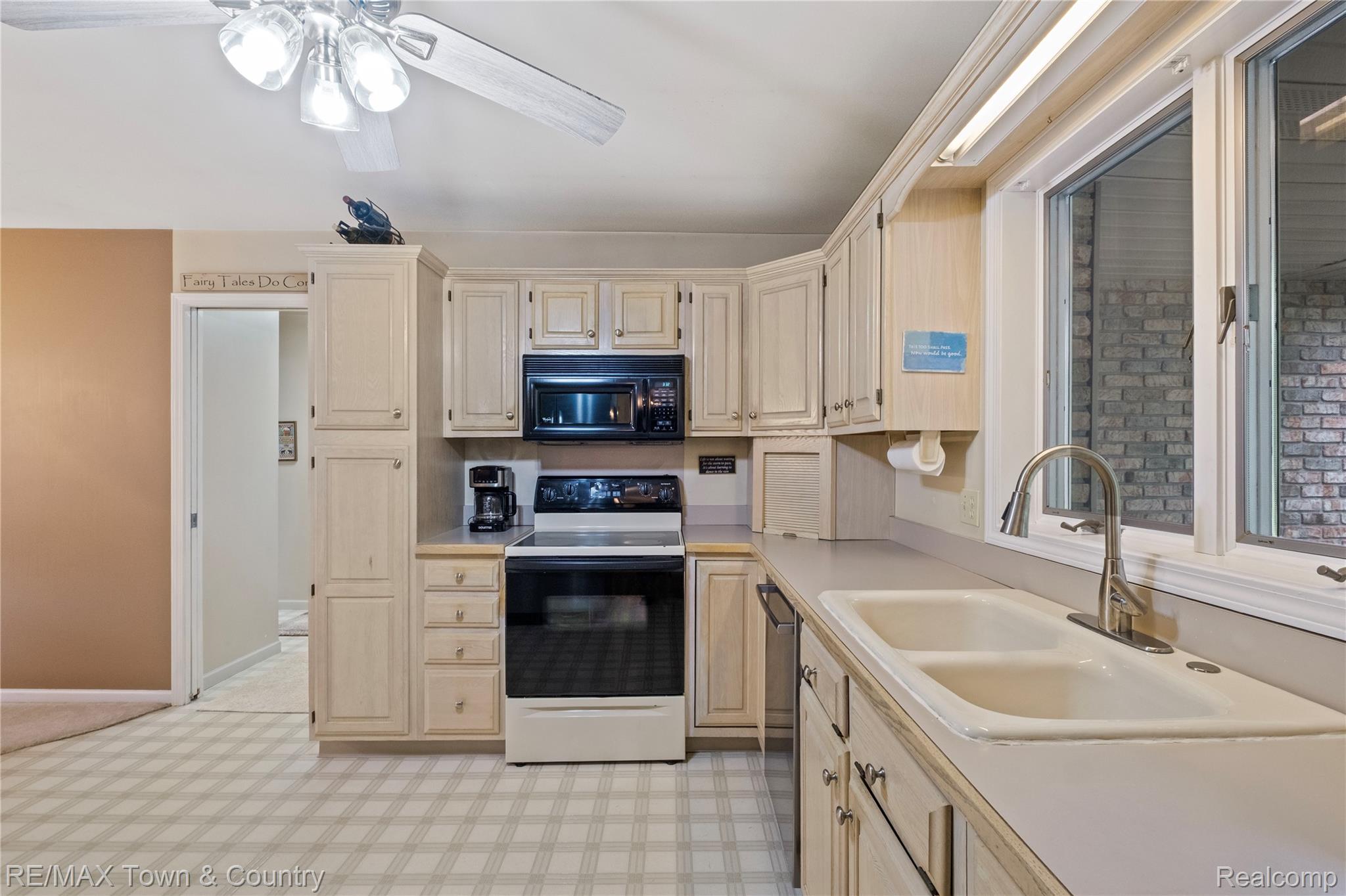 5464 North Seymour Road Flushing, MI 48433 - Photo 16 of 45 Kitchen featuring light-toned cabinetry, a double basin sink with a pull-down faucet, an electric range, and a built-in microwave