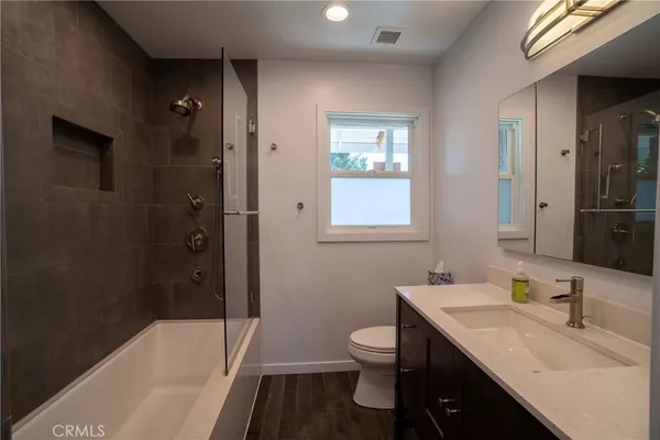a bathroom with a sink toilet tub and shower
