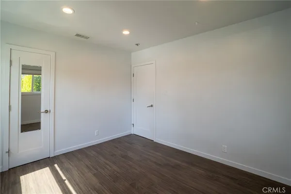a view of an empty room and wooden floor