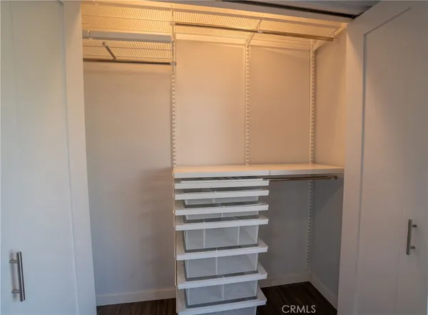 a view of walk in closet with empty racks