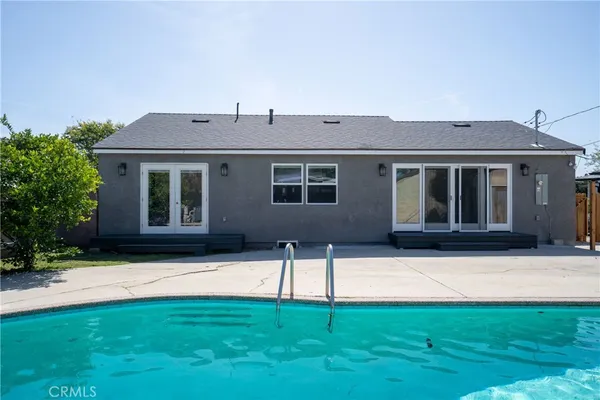 a backyard of a house with table and chairs