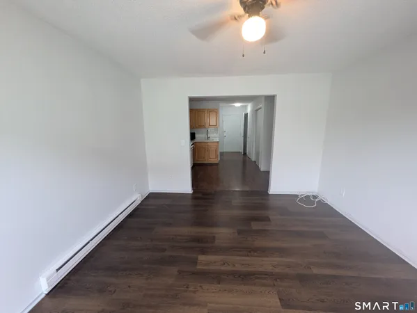 a view of an empty room and wooden floor