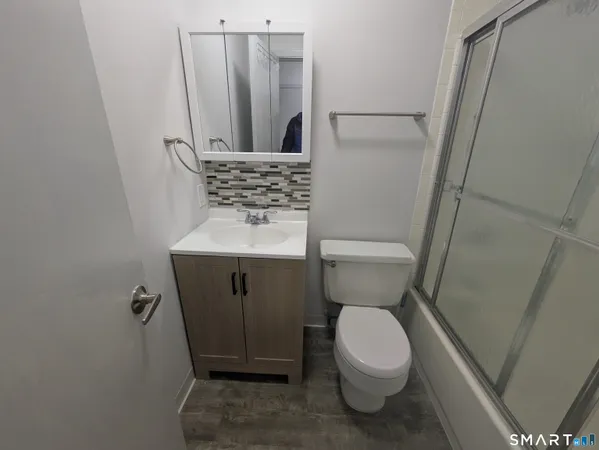 a bathroom with a toilet and a sink