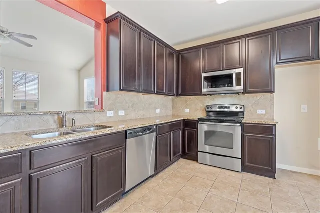 a kitchen with a sink stove and microwave