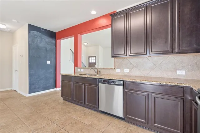 a spacious bathroom with a granite countertop sink and a mirror