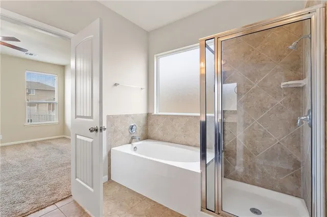 a bathroom with a bathtub and a shower
