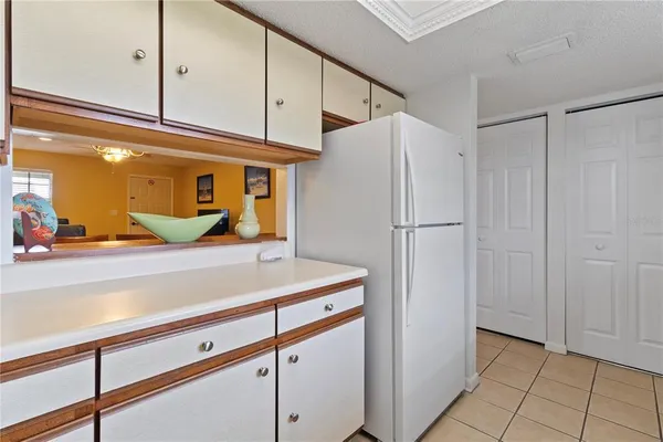 a kitchen with a refrigerator and cabinets