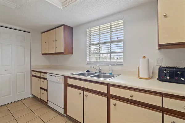 a kitchen with stainless steel appliances granite countertop a sink and a white cabinets