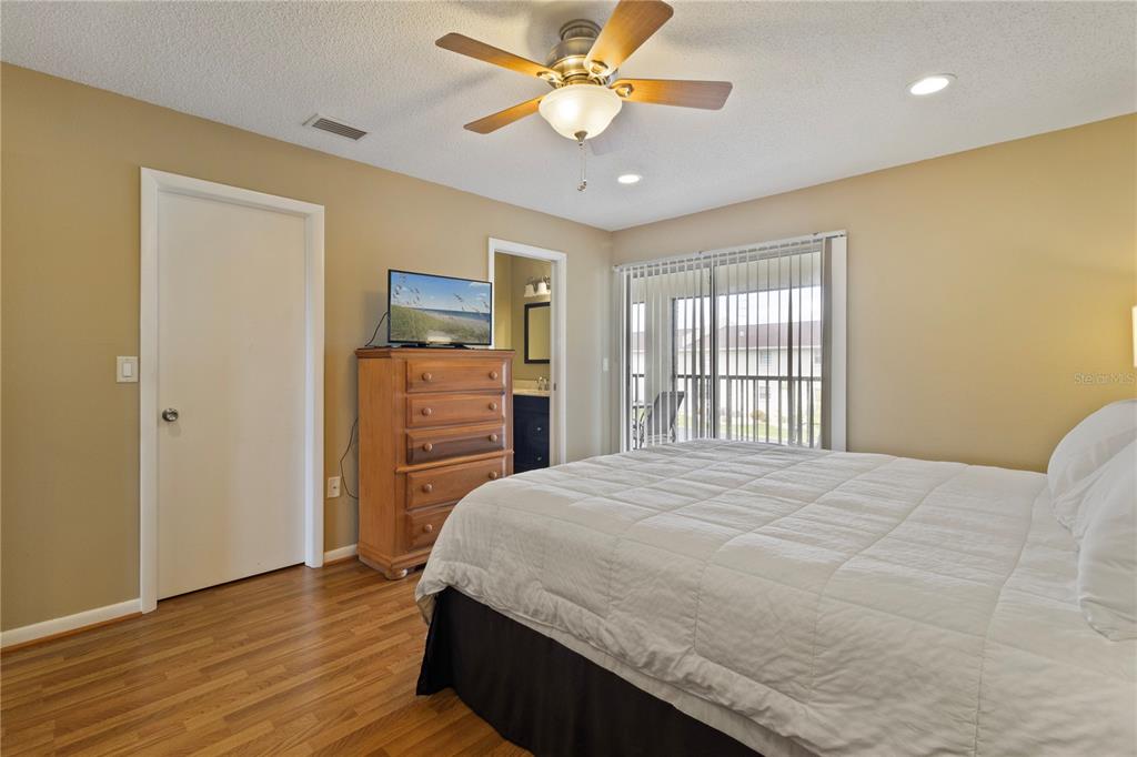 1531 Placida Road, Unit 203 Englewood, FL 34223 - Photo 16 of 28 a bedroom with a bed and a flat screen tv