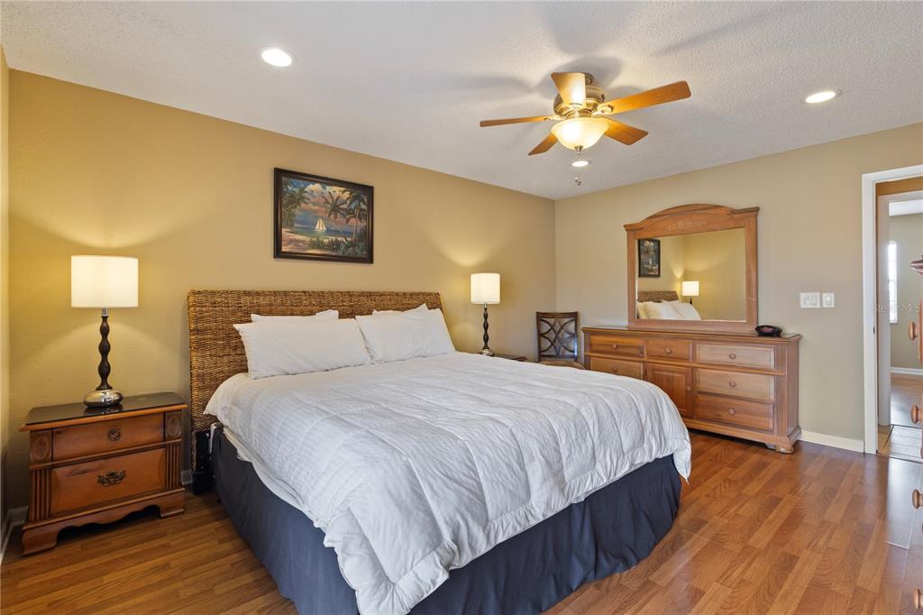 1531 Placida Road, Unit 203 Englewood, FL 34223 - Photo 17 of 28 a bedroom with a bed and a chandelier
