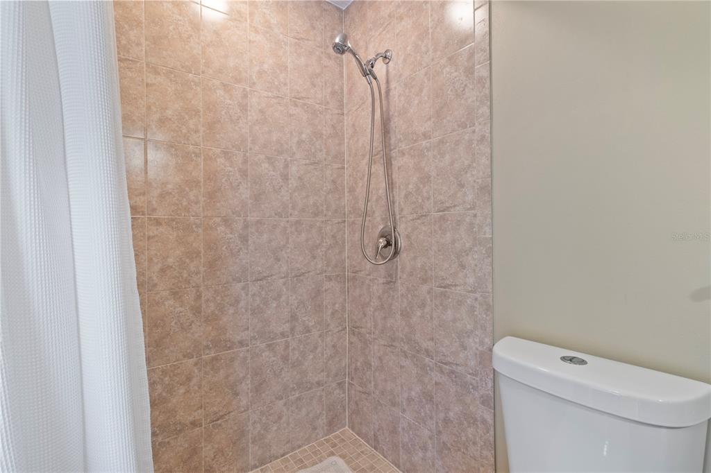 1531 Placida Road, Unit 203 Englewood, FL 34223 - Photo 20 of 28 a white toilet sitting next to a shower