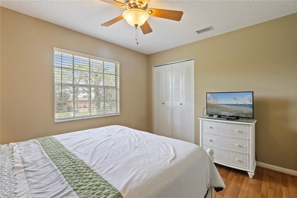 1531 Placida Road, Unit 203 Englewood, FL 34223 - Photo 25 of 28 a bedroom with a bed and a chandelier
