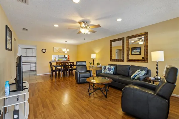 a living room with furniture and a wooden floor