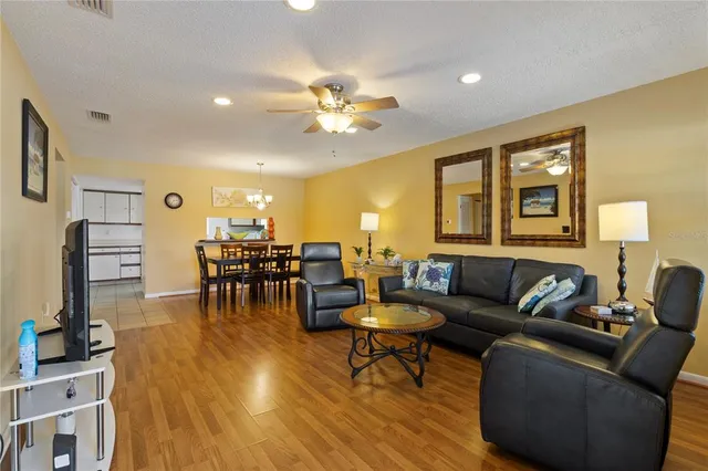 a living room with furniture and a wooden floor
