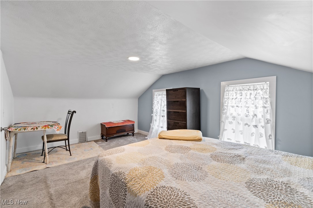 4786 Mayfair Road North Canton, OH 44720 - Photo 23 of 38 Bedroom featuring a textured ceiling, lofted ceiling, and carpet flooring