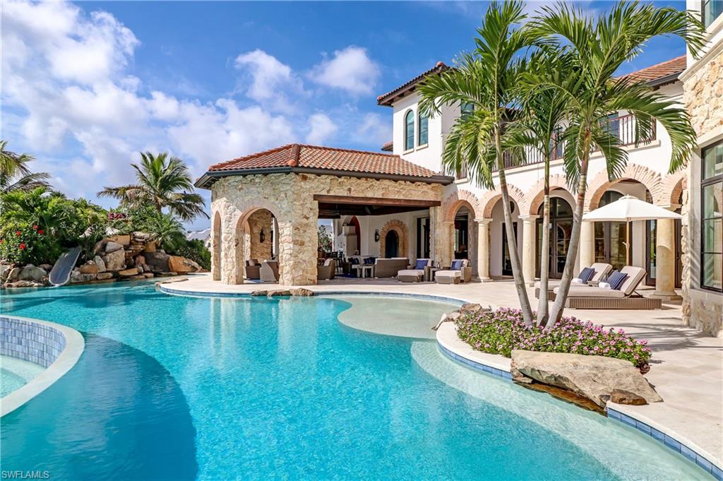 16622 Firenze Way Naples, FL 34110 - Photo 11 of 35 a front view of a house with swimming pool garden and patio