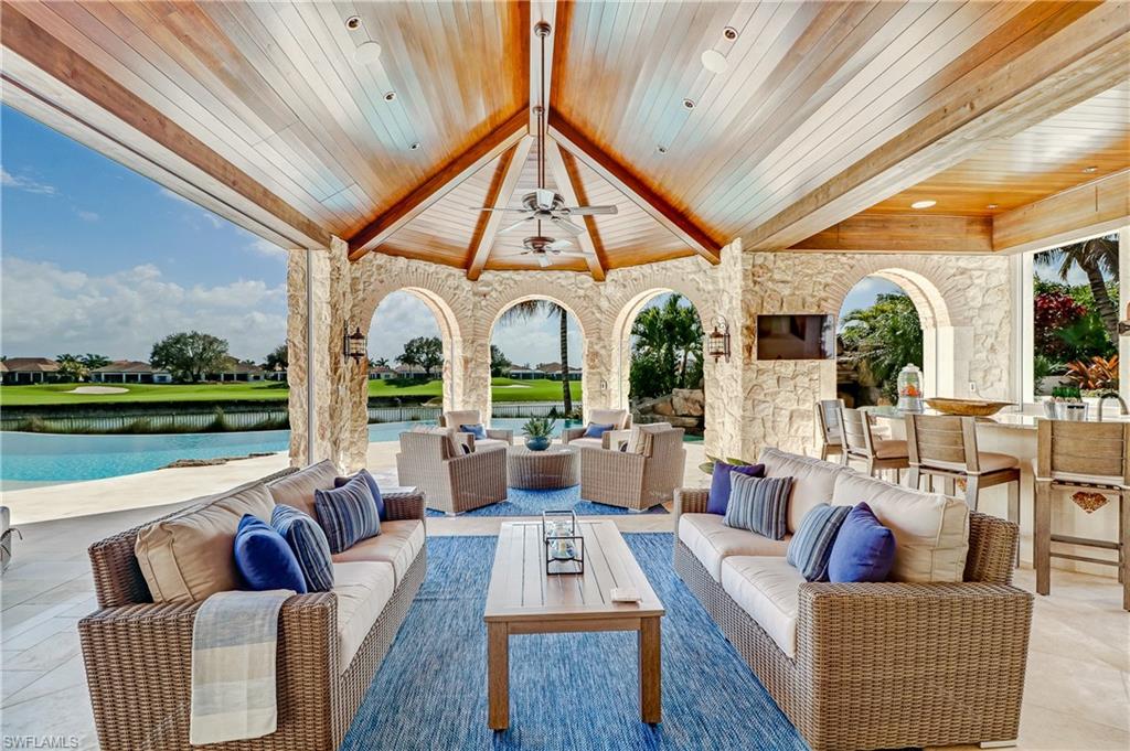 16622 Firenze Way Naples, FL 34110 - Photo 12 of 35 a living room with furniture a large window and a table
