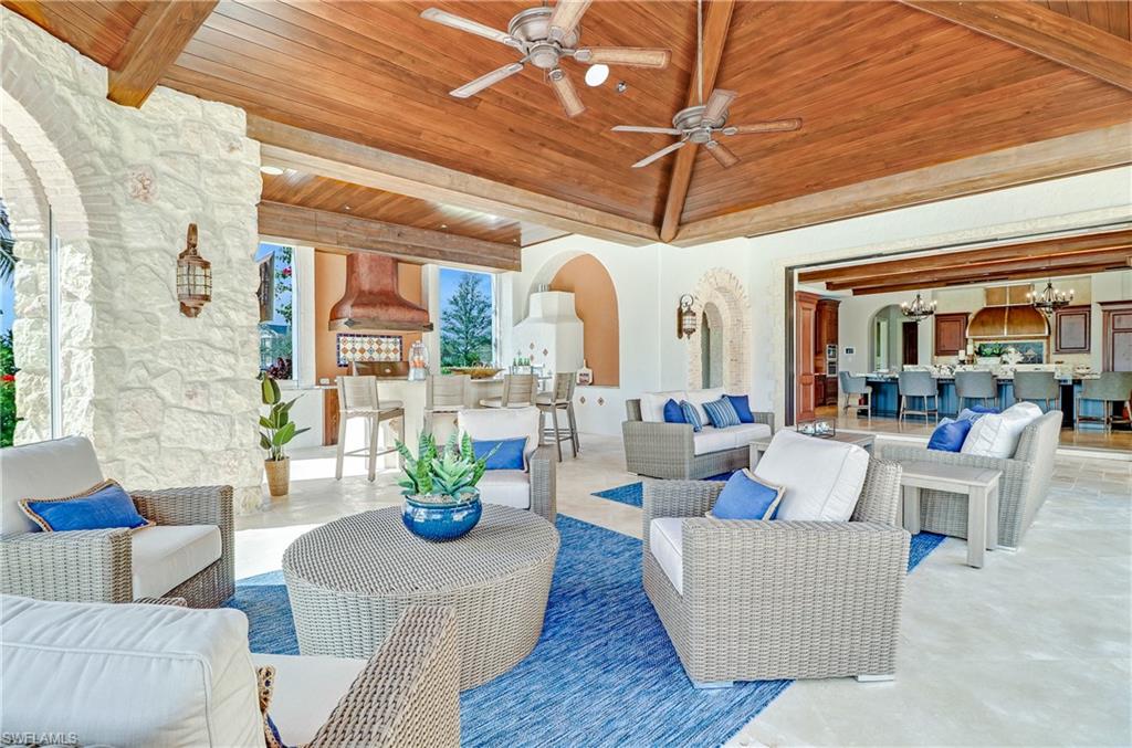 16622 Firenze Way Naples, FL 34110 - Photo 14 of 35 a living room with fireplace furniture and a large window