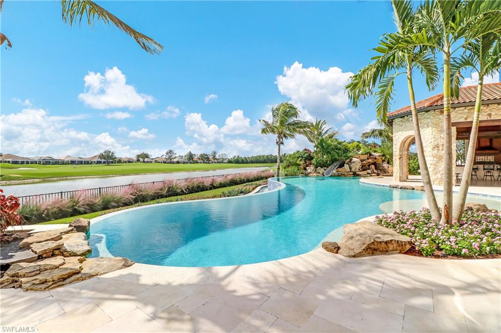 16622 Firenze Way Naples, FL 34110 - Photo 15 of 35 a view of a lake with a house in the background