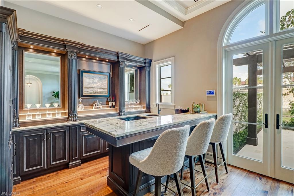 16622 Firenze Way Naples, FL 34110 - Photo 18 of 35 a view of a dining room with furniture and wooden floor